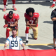 Colin Kaepernick, No. 7, and Eric Reid, No. 35, of the San Francisco 49ers kneel during the national anthem before their game against the Carolina Panthers at Bank of America Stadium on Sept. 18, 2016, in Charlotte, N.C.
Grant Halverson/Getty Images